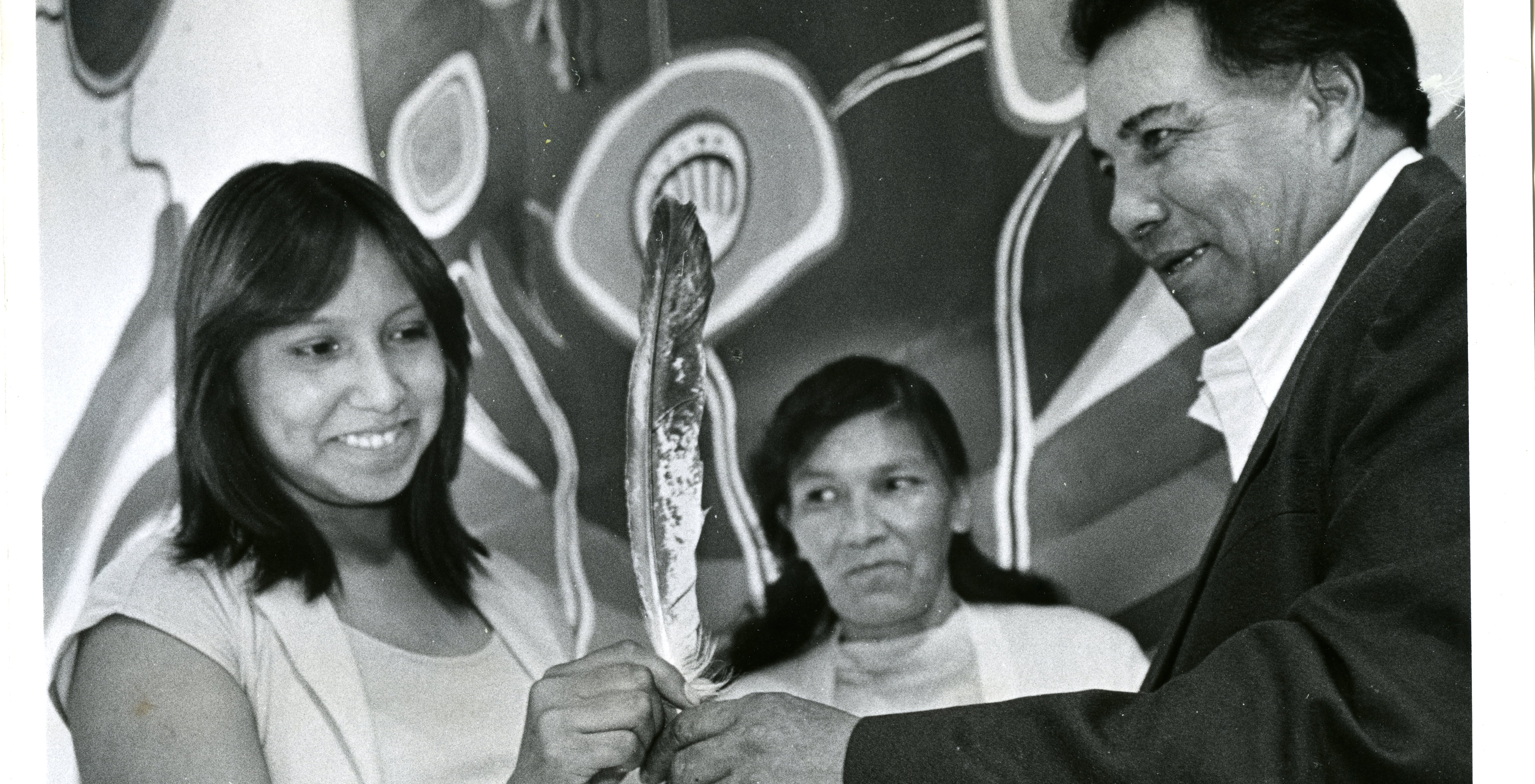 University of Manitoba Archives & Special Collections. Winnipeg Tribune fonds. Hilda Fisher receives an eagle feather from Chief Harry Cook of the Bloodvein First Nation to mark her high school graduation at a ceremony at the Winnipeg Indian and Métis Friendship Centre, July 26, 1980  (PC18-2945-1).